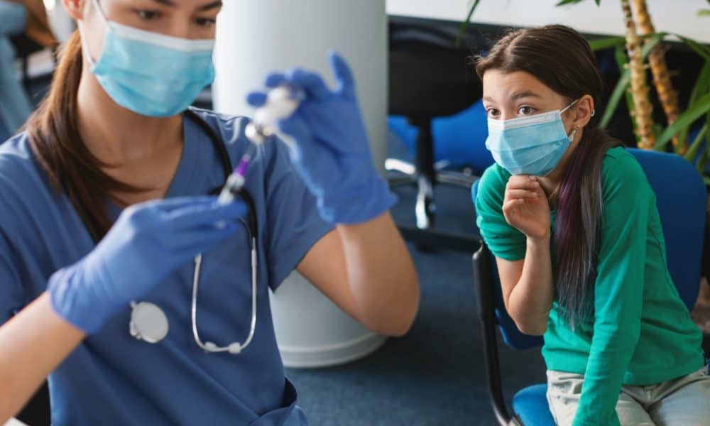 Scared Kid Looking At Nurse Physician With Syringe