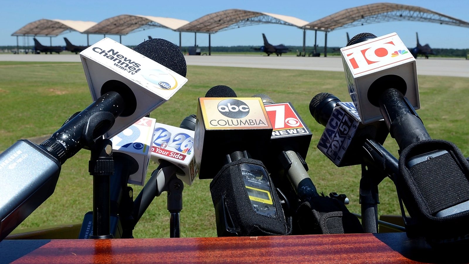 Bank of news media microphones set up for a press conference